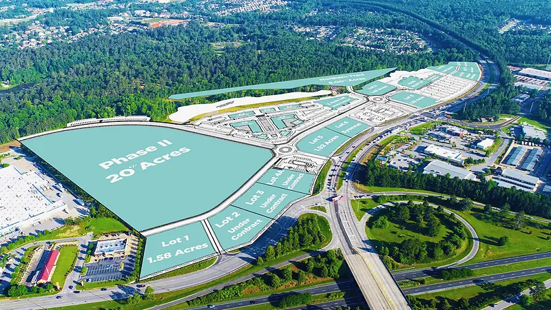Aerial photograph of Midland Commons in Columbus, Georgia overlaid with the MASS Design site plan showing lot parcelisation, acreages and phasing